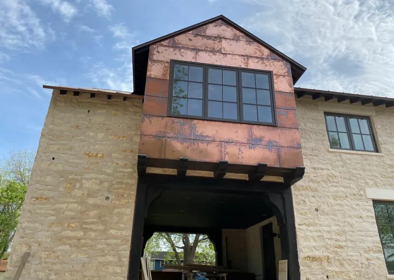 Copper metal panel facade on a stone building for Metal Roof Coating in Grandview